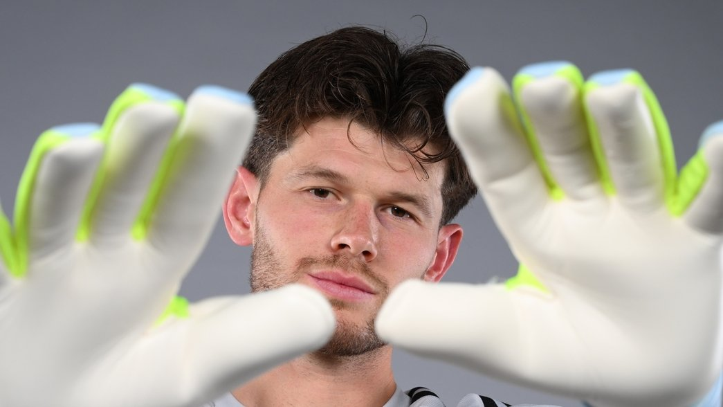 Illan Meslier poses in his new Arsenal shirt